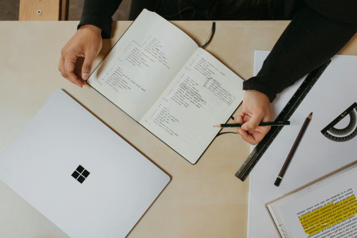 Realtor reviewing schedule and time management tools at desk